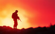 © Curioso.Photography - A silhouette of a soldier standing in front of a vibrant sunset, holding a rifle, symbolizing strength, courage, and resilience.