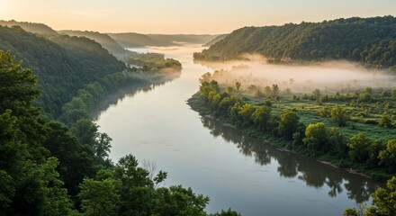 Fototapete - Serene River Valley at Dawn - Misty morning sunrise over a tranquil river valley, lush green foliage, calm water reflecting the sky. Peaceful nature scene