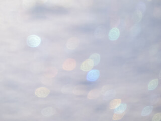 Wall Mural - Artistic, shiny, purposely blurred background with white and colorful bokeh effect of snow in sunlight