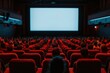 © darshika - A movie theater filled with people watching a blank screen, red seats and dark ambiance.