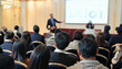 © KAMAPAN - Speaker giving a talk in conference hall at business event. Rear view of unrecognizable people in audience at the conference hall. Business and entrepreneurship concept