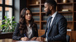 © Rich - Black Male and Female Attorneys Discussing Documents in a Modern Office