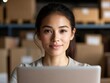 © Arti - Woman works with laptop at warehouse