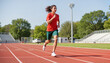© Andrey - Young athlete running on a track field in a sunny day