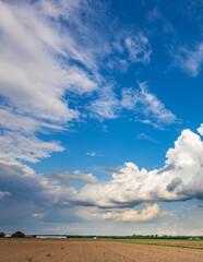 Wall Mural - cloudy sky with a few clouds in the distance