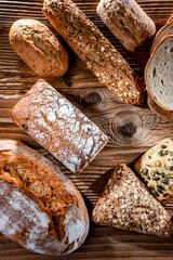 Fototapete - Assorted bakery products including loaves of bread and rolls