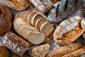 Fototapete - Assorted bakery products including loaves of bread and rolls