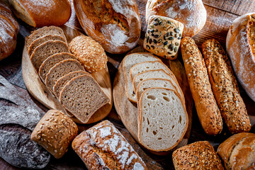 Fototapete - Assorted bakery products including loaves of bread and rolls
