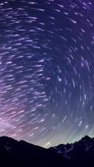 Wall Mural - vertical 9:16 Timelapse, stars move slowly across the night sky as occasional shooting stars streak through the atmosphere. The Milky Way glows above a silhouetted mountain range