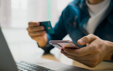concept that men use credit cards for online shopping and digital payment through mobile application