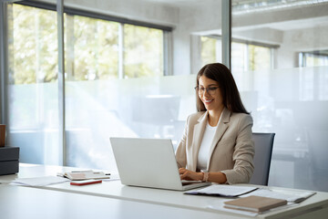 young professional it specialist latin hispanic business lady working on laptop pc sitting at desk i