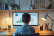 © Nataliia - Boy sitting at desk and analyzing colorful charts and graphs on computer screen in cozy home office environment