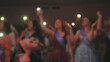 © Довидович Михаил - Group of students waving illuminated cell phones at graduation party, celebrating friendship and academic achievement