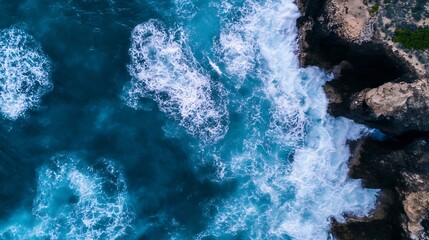 Leinwandbilder - Aerial view of ocean waves crashing against rocky coastline showcasing vibrant blue water : Generative AI
