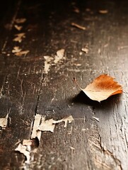 Poster - Single dried autumn leaf resting on a weathered wooden surface capturing the essence of fall : Generative AI