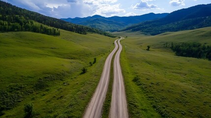 Aufkleber - Breathtaking aerial view of a winding dirt road through expansive green meadows and scenic mountain landscapes : Generative AI