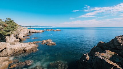 Leinwandbilder - Stunning coastal view of serene blue waters meeting rocky shore under a bright blue sky : Generative AI