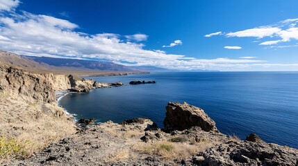 Aufkleber - Stunning coastal landscape with rocky cliffs and a calm sea under a bright blue sky : Generative AI