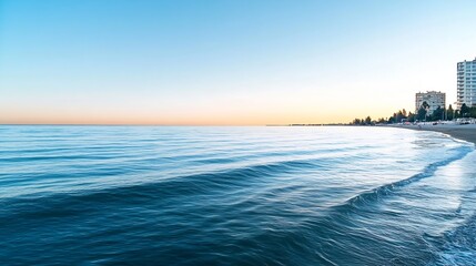 Aufkleber - Calm ocean waves gently lapping against the shore at sunset with a beautiful skyline in the background : Generative AI