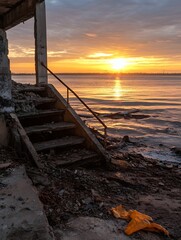 Aufkleber - Ruined Structure Overlooking Calm Waters at Sunset with Litter Along the Shoreline : Generative AI