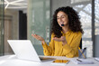 © Liubomir - Support service worker at workplace inside office. Businesswoman talking using laptop for video call. Woman smiling and talking, consulting clients remotely.