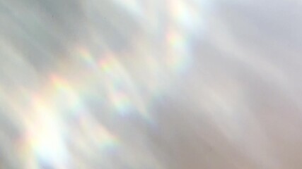 A dreamy, abstract overlay of soft light reflections creating a blurred rainbow effect. Ideal for serene, ethereal, or inspirational stock footage backgrounds.