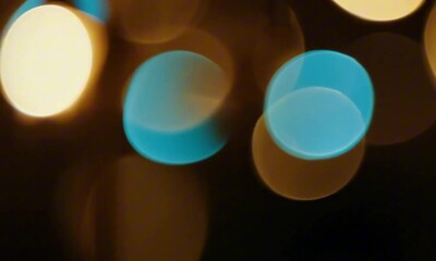Wall Mural - Out-of-focus golden and blue lights twinkle softly against a dark background, creating a dreamy bokeh effect. The light sources subtly shift, forming a gentle, hypnotic motion. Diffused lighting