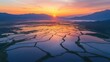 © AnCreaSpace - Sunrise Over Watery Rice Paddies and Mountains