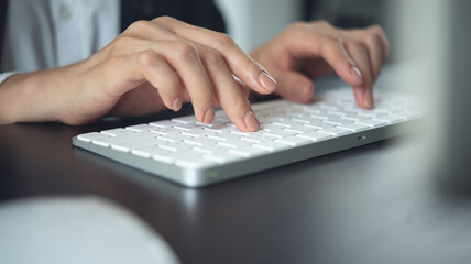 Wall Mural - closeup, business woman hand typing on desktop computer keyboard, online working, searching the info