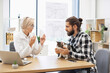 © sofiko14 - Male pet owner holding a cat consulting female veterinarian in bright office environment. Discussion involves animal health and medications for treatment or prevention.
