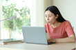 © Antonioguillem - Amazed asian woman checking content on laptop
