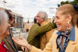 © Westend61 - Senior friends socializing and hugging outdoors in an urban setting