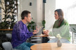 © Westend61 - Two people having a business discussion in a caf� with a laptop
