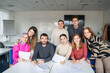 © Westend61 - Group of students from different nationalities sitting at desks in a multicultural classroom setting