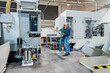 © Westend61 - Two people in a production hall discussing machine systems