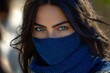 © ChaoticMind - Woman with striking blue eyes wearing a blue neck gaiter in a natural outdoor setting during the day