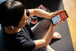 © Davor - Woman tracking workout progress on fitness app after exercise