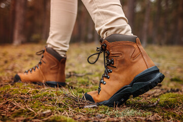 Wall Mural - hiking boot. legs in leather ankle boots walks in forest