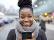 © Dil - Smiling woman outdoors using phone.