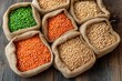© Віталій Б. - Brightly colored lentils and peas are displayed in burlap sacks on a rustic wooden table. The arrangement showcases various hues like green, orange, and beige, highlighting their natural beauty