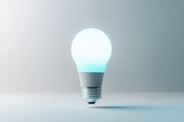 Wall Mural - a glowing led lightbulb, illuminated with a soft teal light, sits on a minimalist white surface.