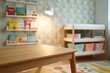 © Евгения Жигалкина - empty honey-toned wooden table sits centered in a whimsical baby room, with hand-painted woodland creatures adorning the pastel-colored walls. A mobile featuring fabric stars and moons gently hangs in