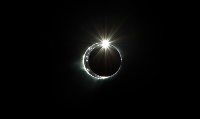 Wall Mural - a black and white photo of a crescent moon with a bright light shining on it. solar eclipse