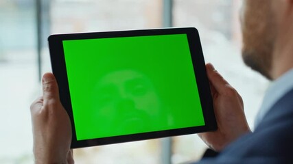 Hands holding mockup tablet browsing internet application closeup. Unknown man
