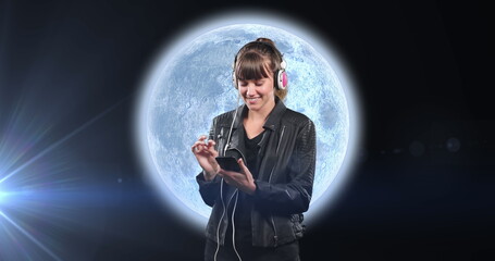 Wall Mural - image of smiling woman planet earth with glowing spots of light and clouds on grey background