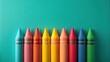© Jane Studio - A vibrant row of colorful wax crayons arranged against a teal background, ready for creative expression and artistic endeavors