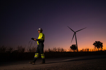 Aufkleber - Engineer man working with tablet at windmill farm Generating electricity clean energy. Wind turbine farm generator by alternative green energy.