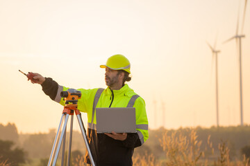 Aufkleber - Engineer working on laptop in front of wind turbines for checking wind turbines of the field during beautiful sunset. Alternative energy concept.