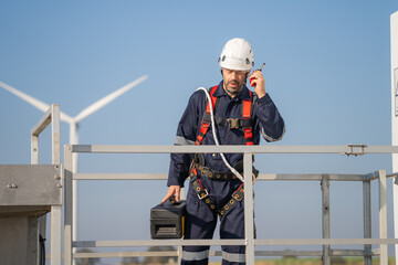 Fototapete - Engineer man working at windmill farm Generating electricity clean energy. Wind turbine farm generator by alternative green energy.