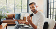 © peopleimages.com - Home, man and smile with laptop for credit card, password or banking app for subscription. House, male person and happiness with tech for debit details, online shopping or payment for website on sofa